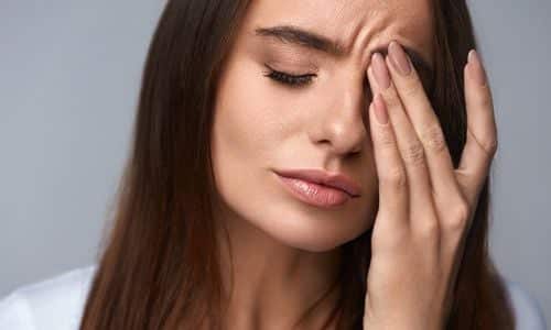 Woman experiencing eye spasm