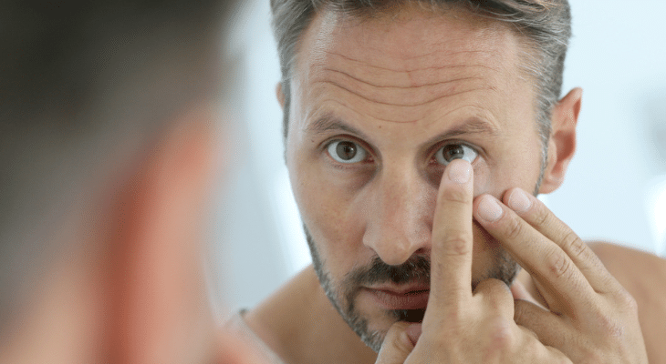 Man puts multifocal contacts in his eyes.