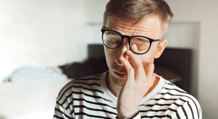 Man rubbing eyes